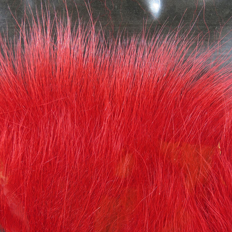 Colorful fox tail hair on a wooden surface