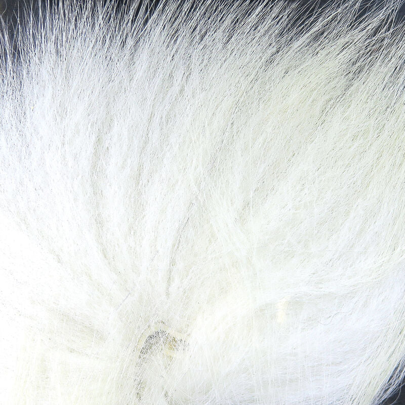 White fox tail hair on a wooden surface