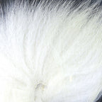 White fox tail hair on a wooden surface