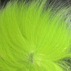 Chartreuse fox tail hair on a wooden surface