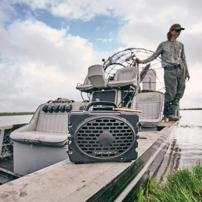 Person on an airboat with a portable Turtlebox Original Gen 3 on a dock.