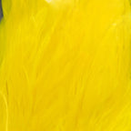 Close-up of bright yellow Spirit River UV2 Schlappen products on a wooden surface