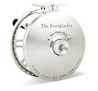 A collection of Tibor fly fishing reels in different colors displayed horizontally. The reels are labeled with their model names.