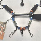 Mountain River Lanyard, The Angler with beads and metal components on a textured surface