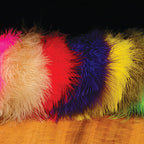 Set of colorful  Hareline X-Select Marabou feathers on a wooden surface with a dark background