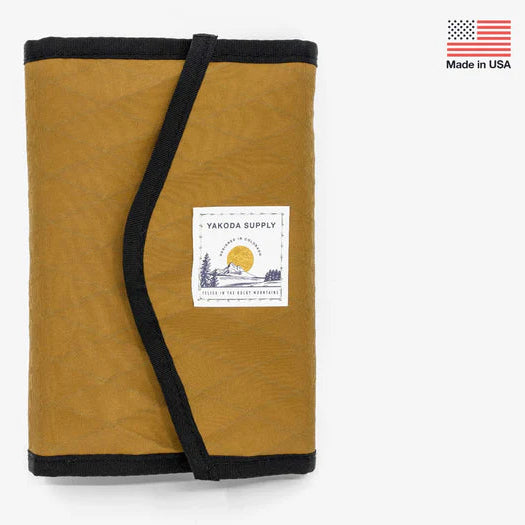 Brown fabric Yakoda STS Stash with Umpqua branding with black trim and a visible label on a white background