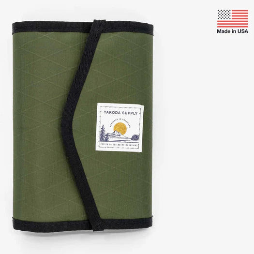 Green Yakoda STS Stash with Umpqua branding held with black strap and a label on a white background