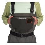 Person wearing a black Simms MEN's G3 Guide Stockingfoot Waders with Simms logo on a white background