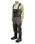 Person wearing gray Simms MEN's G3 Guide Stockingfoot Waders and a light green shirt on a white background