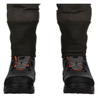 Black winter boots with orange accents worn with Simms MEN's G3 Guide Stockingfoot Waders on a white background