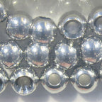 Silver metal beads for fly tying on a white background
