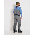 A fisherman with a pair of gray zippered Orvis men's PRO fly-fishing waders with suspenders and boots.