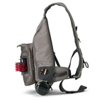 A gray Orvis sling pack designed for fly-fishing, featuring multiple storage compartments and oa water bottle holder.