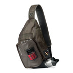 A gray Orvis sling pack designed for fly-fishing, featuring multiple storage compartments and oa water bottle holder.