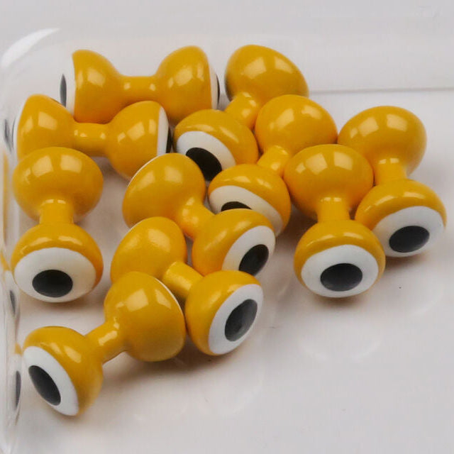 Yellow Hareline Double Pupil Lead Eyes eyes with black pupils on a white surface