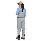 Person wearing Orvis women waders with suspenders on a white background. View from the back. 