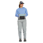 Person wearing gray Orvis women waders with suspenders on a white background