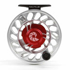 A silver and red Nautilus CCF-X2 fly-fishing reel with a large arbor design.