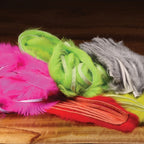 Colorful Hareline 1/8" Crosscut Rabbit Strips on a desk