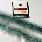 A product image featuring a package with the text 'Flash Blend Baitfish Brush' and a visual representation of the brush made of synthetic fibers in green and blue hues.
