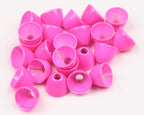 Pink Hareline Brass Cone Heads on a white surface