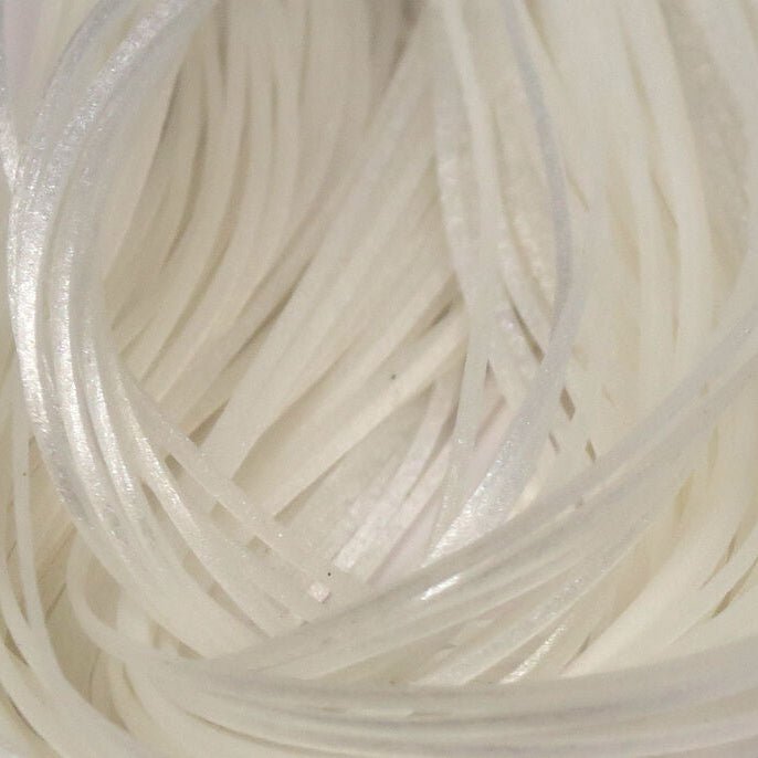 Close-up of white Hareline Crazy Legs stacked together