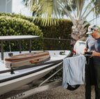 A Fishpond Dakota Rod & Reel Case laying on the deck of a flat skiff boat. 