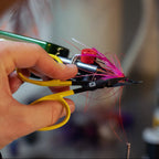 Hand holding a Loon Ergo All Purpose Scissors, blurred background