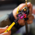 A Loon Ergo Dubbing Brush with a yellow powder-coated handle and black nylon bristles.