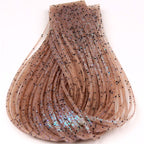Close-up of dark tan Hareline Loco Legs on a white surface