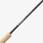 Close-up of a Sage ESN fly fishing rod with black ice thread wraps and a light colored handle.