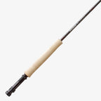 Close-up of a Sage ESN fly fishing rod with black ice thread wraps and a light colored handle.