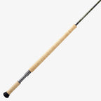A two-handed Sage Sonic Switch and Spey Fly Rod with a cork handle and a graphite rod body, featuring charcoal and gunmetal trim wraps.