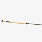 A two-handed Sage Sonic Switch and Spey Fly Rod with a cork handle and a graphite rod body, featuring charcoal and gunmetal trim wraps.