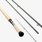 A two-handed Sage Sonic Switch and Spey Fly Rod with a cork handle and a graphite rod body, featuring charcoal and gunmetal trim wraps.