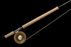 A two-handed Sage Sonic Switch and Spey Fly Rod with a cork handle and a graphite rod body, featuring charcoal and gunmetal trim wraps.