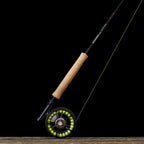Close-up of a Sage ESN fly fishing rod with black ice thread wraps and a light colored handle.