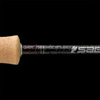 Close-up of a Sage ESN fly fishing rod with black ice thread wraps and a light colored handle.
