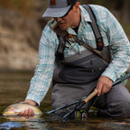 Close-up of a Sage ESN fly fishing rod with black ice thread wraps and a light colored handle.