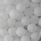A close-up image of white round fishing beads with a hole in the center for stringing purposes.