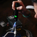 Person using a UV light to cure something on a fly tying vise 