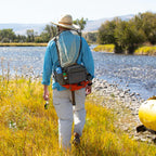 Angler wearing a Fishpond Waterdance Pro Guide Pack outdoors