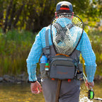 Angler wearing a Fishpond Waterdance Pro Guide Pack outdoors