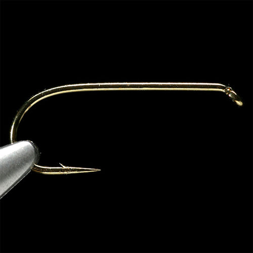 Gold-colored Daiichi 1180 dry fly fishing hook on a black background