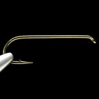 A single gold-colored Daiichit 2220 4X-long streamer fishing hook against a black background.
