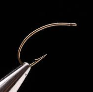 A close-up of a single Daiichi 1160 fly fishing hook with a bronze finish.