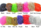 A selection of colorful chenille materials for fly tying, displayed in a line with each end showing the translucent fibers.
