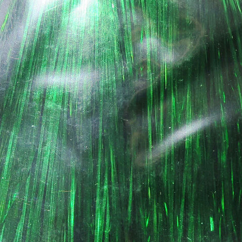 Close-up of green metallic Hedron Flashabou on a textured surface