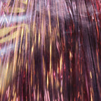 Close-up of tinsel with reflective strands on a dark background