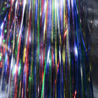 Close-up of multicolored tinsel strands on a dark background